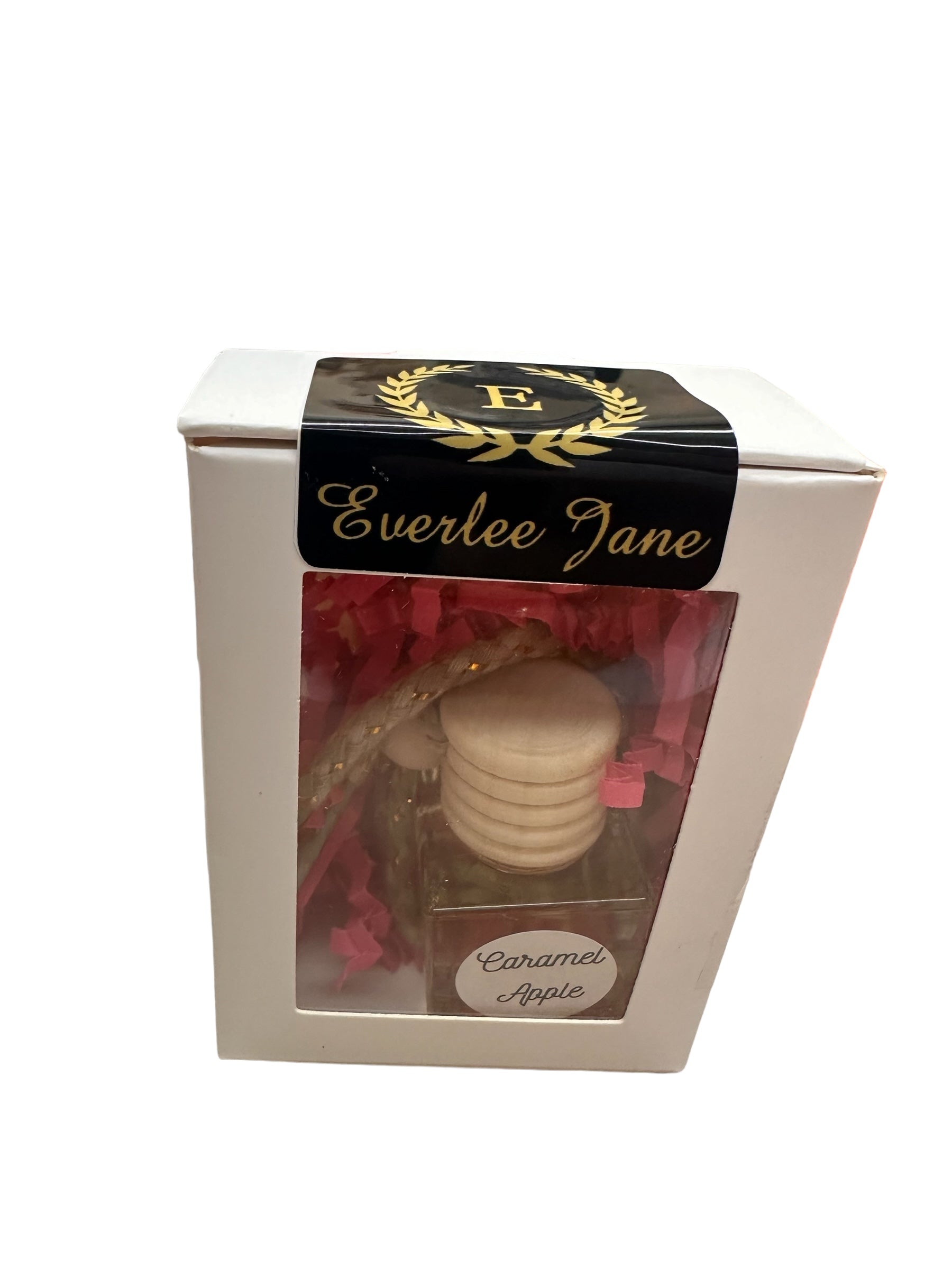 Glass bottle car diffuser labeled "Caramel Apple" with a wooden cork. Packaged with pink and red decorative shredded paper inside a box with a window. Branded "Everlee Jane". Available size: Small.