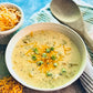 Creamy Broccoli Cheddar Soup Mix with shredded cheddar and green onions. Available in small, medium, and large sizes.