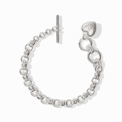 Silver bracelet with circular links, toggle clasp, and textured cubic zirconia heart charm. Available in 6”, 7”, and 8”.