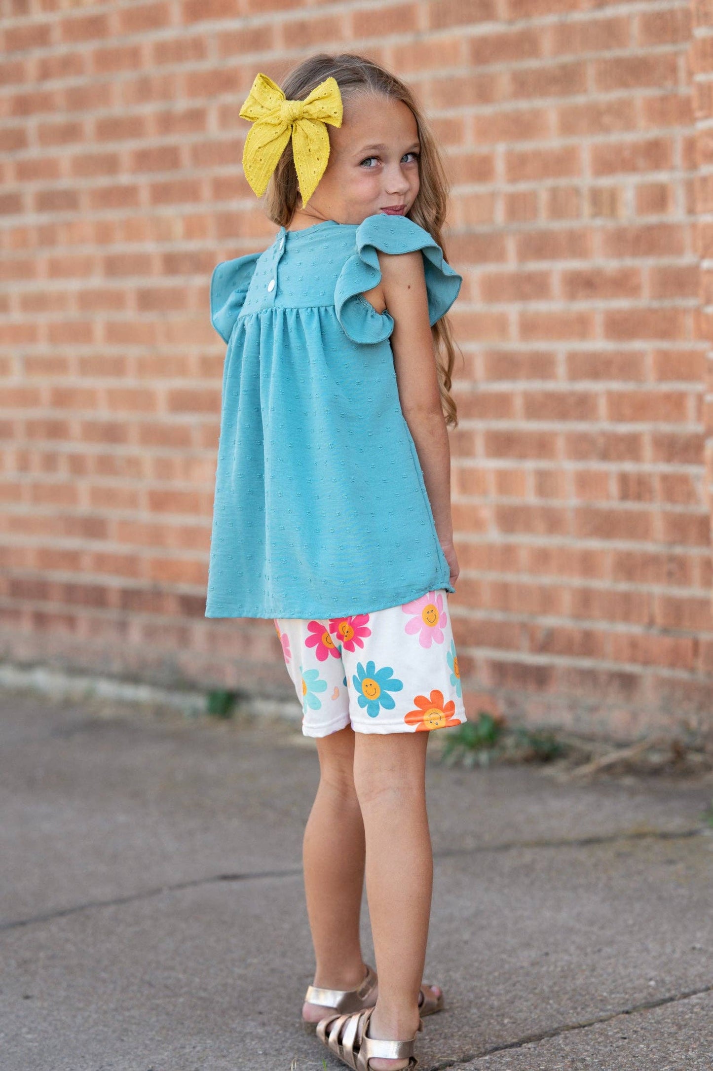 Girls Happy Flower Short Set: teal swiss dot flutter sleeve top, floral shorts. Available in sizes 2T–10.
