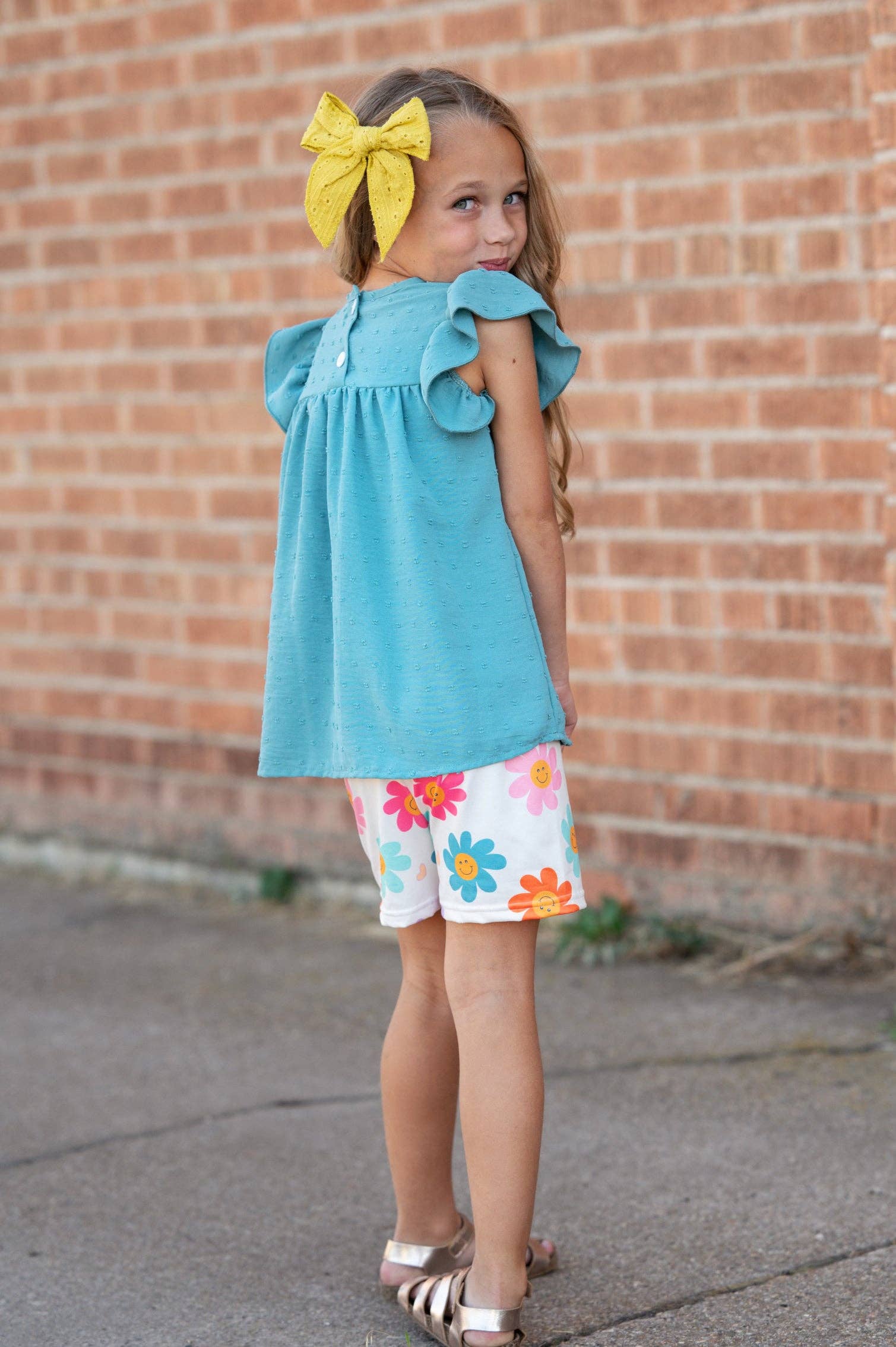 Girls Happy Flower Short Set: teal swiss dot flutter sleeve top, floral shorts. Available in sizes 2T–10.