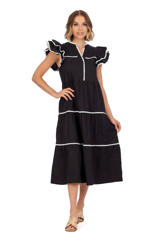 Pia Ric Rac Midi Dress: Black cotton poplin with white trim and flutter sleeves. Tiered design, midi length. Sizes available: XS, S, M, L, XL.