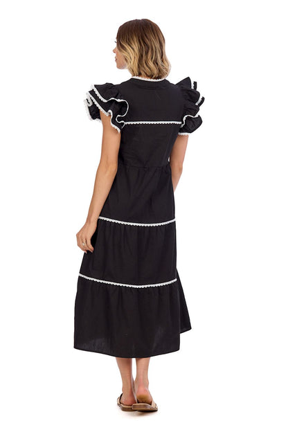 The Pia Ric Rac Midi Dress features ruffled sleeves and white trim. Available in sizes XS to XL.