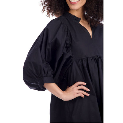 Black Shipley Dress in cotton poplin with puff sleeves and ruffled neckline. Sizes XS–XL available.