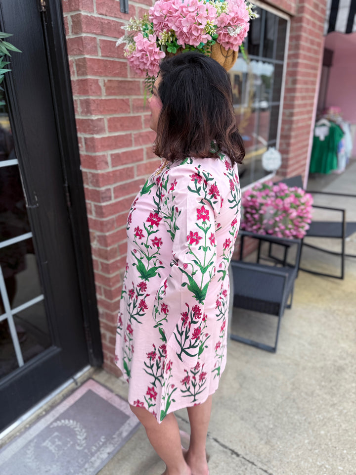Rose D’ Iris Eloise Mini Caftan: hand-block printed pink mini dress with red and green floral patterns. Available in sizes XS–XL.