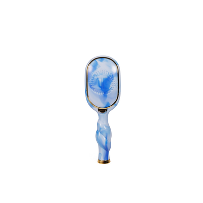 Blue and white marbled Mini Boar Brush with rectangular head, gold accents, and natural boar bristles; available in travel size.