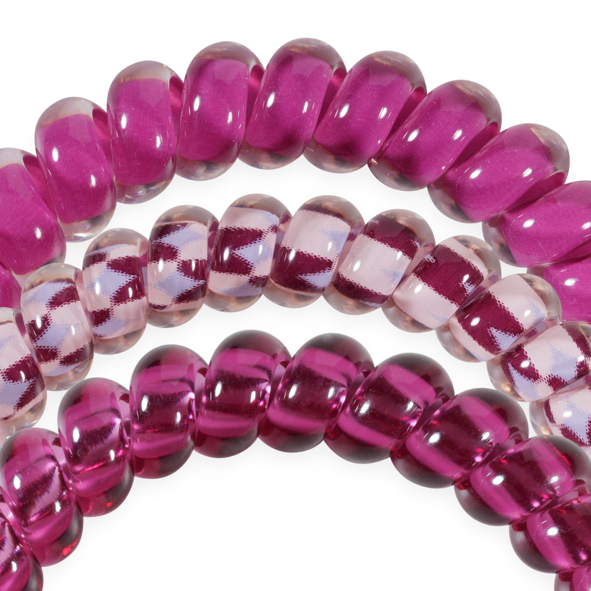 Set of three small Merlot after Midnight TELETIES hair ties in deep wine and clear shades, featuring spiral coils for a shiny, no-crease hold. Available in small size.