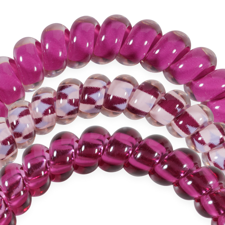 Set of three small Merlot after Midnight TELETIES hair ties in deep wine and clear shades, featuring spiral coils for a shiny, no-crease hold. Available in small size.