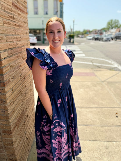 Navy Smocked Border Dress shown. Available in sizes XS–XL.