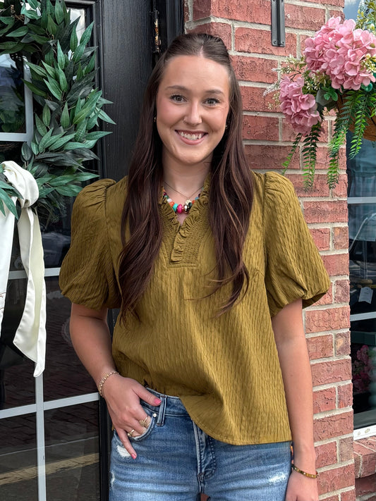 Olive Ruffled Blouse with a relaxed silhouette, available in sizes XS-XL.