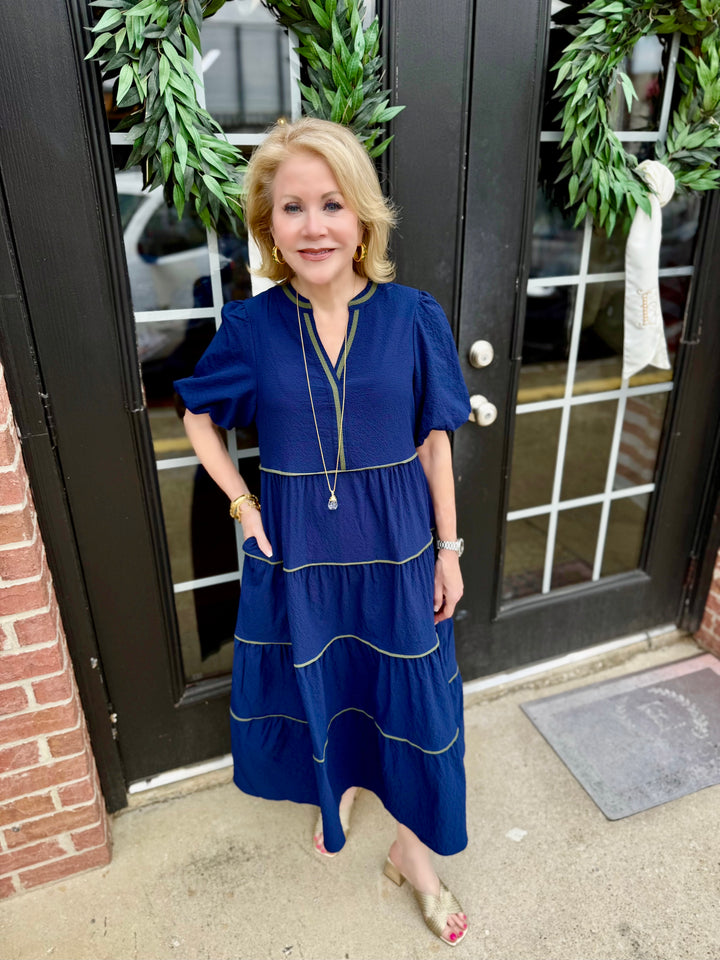 Kinsley Navy Seersucker Dress in available sizes XS-XL. Features textured fabric and classic navy color.
