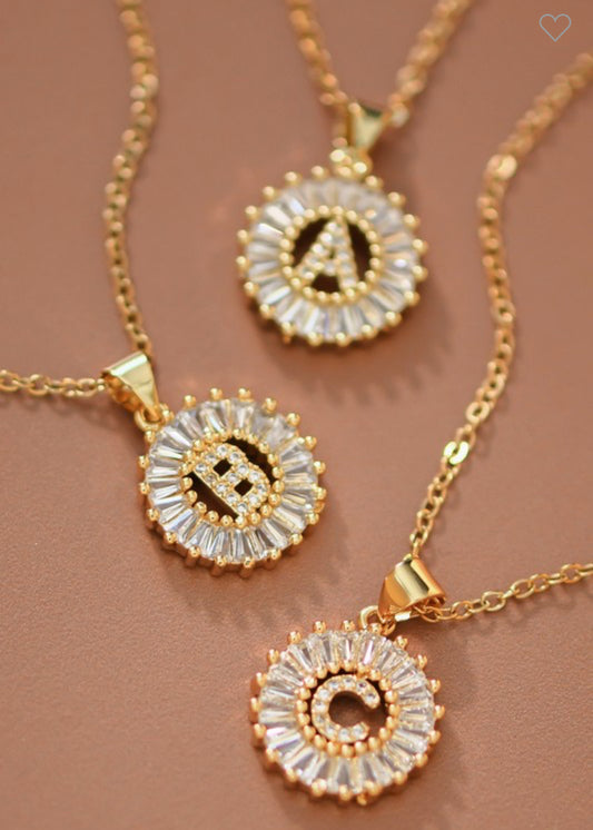 Stainless steel necklaces with round CZ initial pendants, letters A, B, and C. Available in sizes 16", 18", and 20".