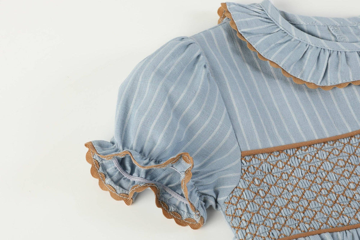 Blue Pinstripe Brown Smocked Ruffle Collar Dress in size 12-18M features light blue fabric with white vertical stripes, puffed short sleeves, ruffled collar and cuffs, brown lace trim, and a brown diamond-patterned smocked panel on the front.