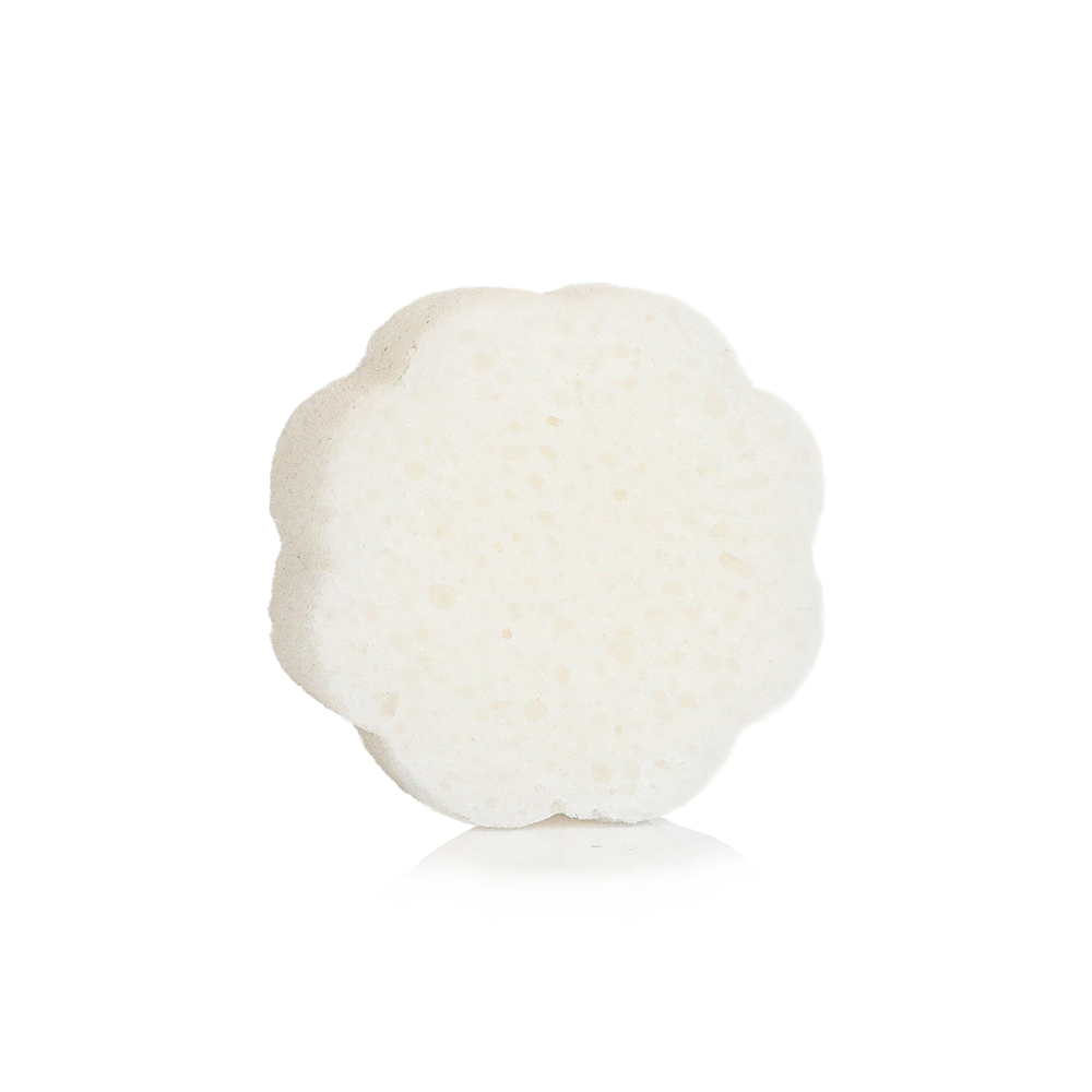 White, flower-shaped, porous French Lavender Daisy Spongette bath sponge; available in regular and travel sizes.