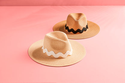 Woven paper straw fedora with white band. Sizes: Small, Medium, Large. Ric Rac Fedora with oversized black ric-rac ribbon trim. Sizes: Small, Medium, Large.