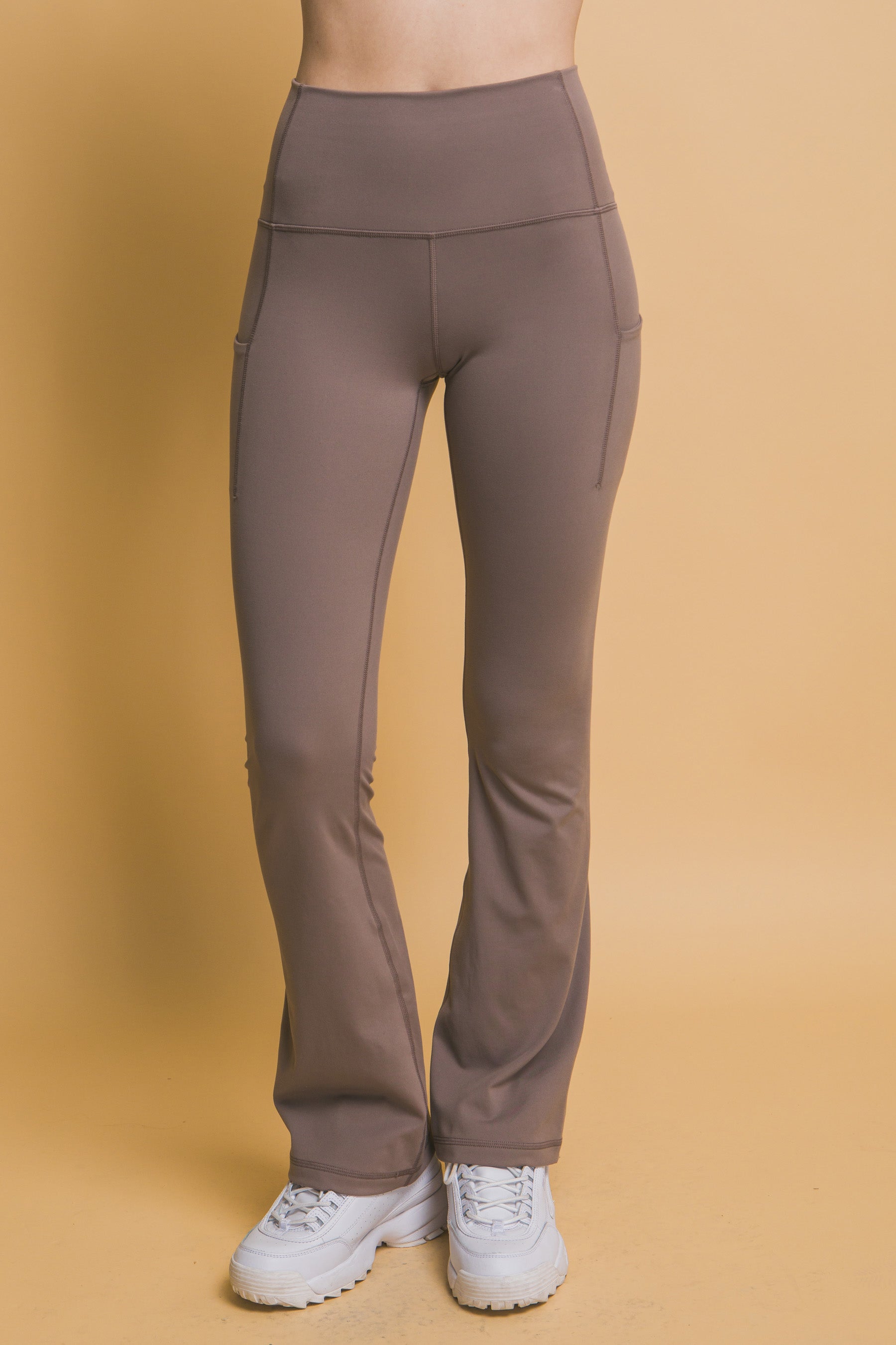 High-Waisted Flared Leggings with Side Pockets, buttery soft, fitted with flared bottoms. Available sizes: XS, S, M, L, XL.