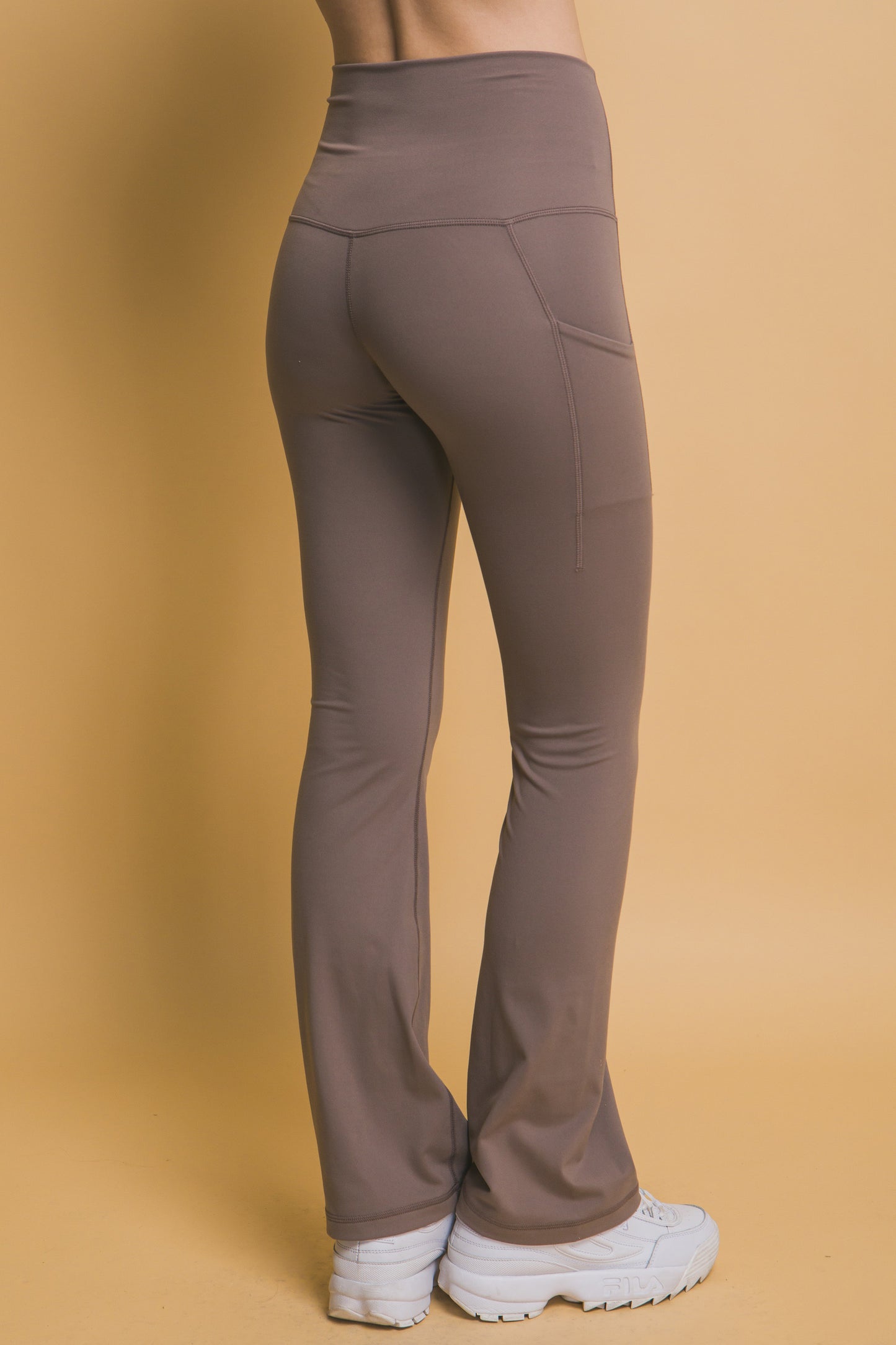 High-Waisted Flared Leggings with side pockets, buttery soft feel. Sizes available: XS, S, M, L, XL.