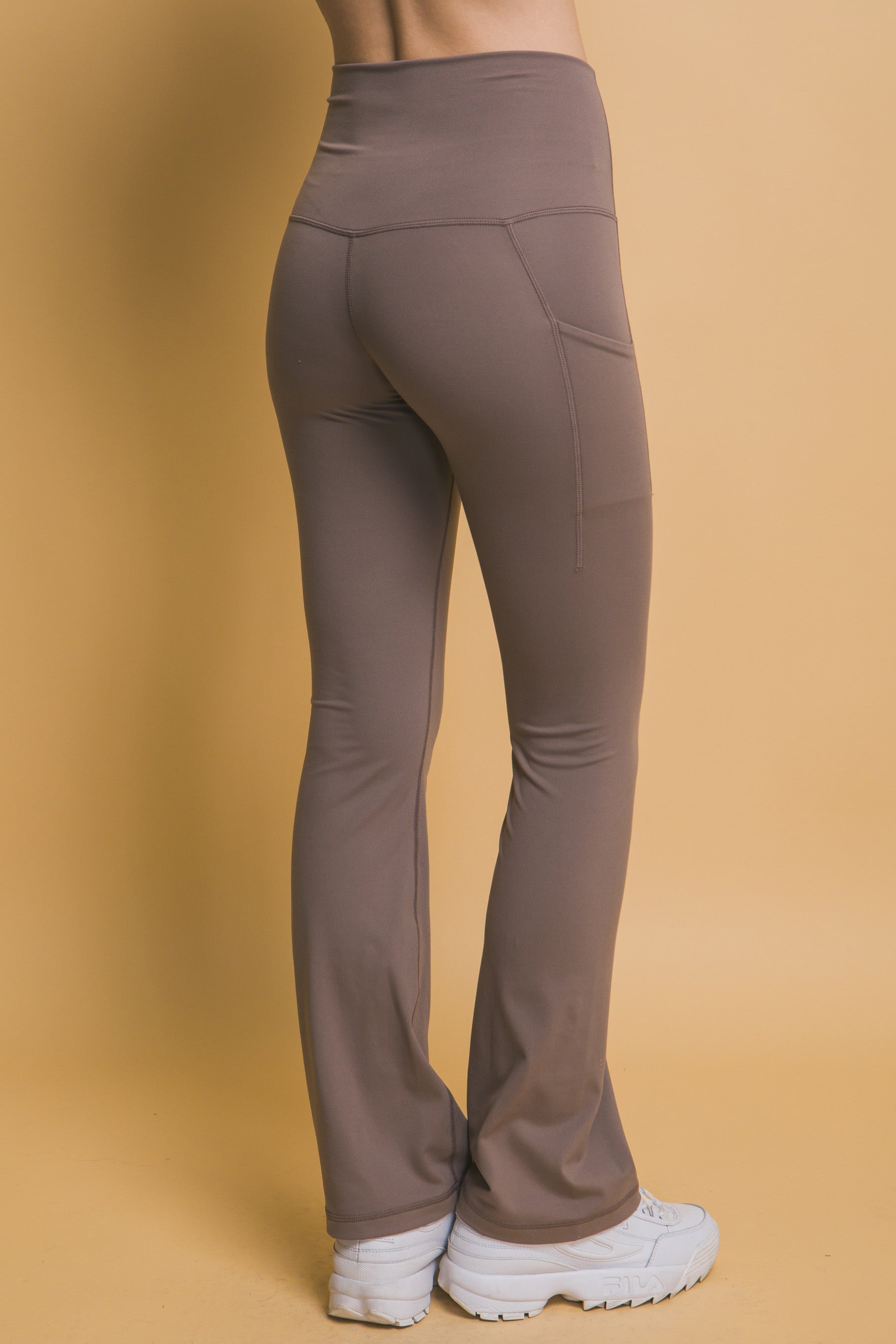 High-Waisted Flared Leggings with side pockets, buttery soft feel. Sizes available: XS, S, M, L, XL.