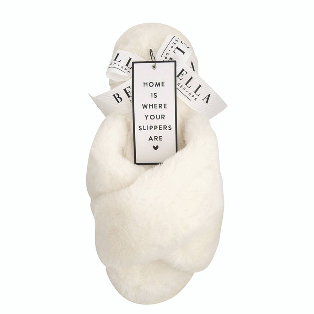 Ivory Criss-Cross Plush Slippers with fluffy white fabric, tag, and ribbon. Available in S, M, L, XL.