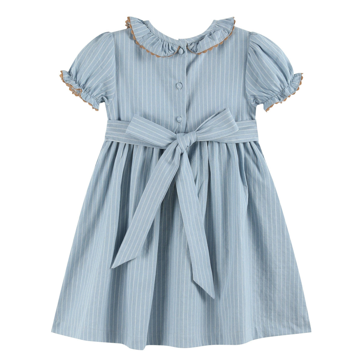 Light blue girls’ dress with white pinstripes, smocked ruffle collar with brown trim, puffed sleeves edged in brown ruffles, and a large waist bow. Size: 12-18M.
