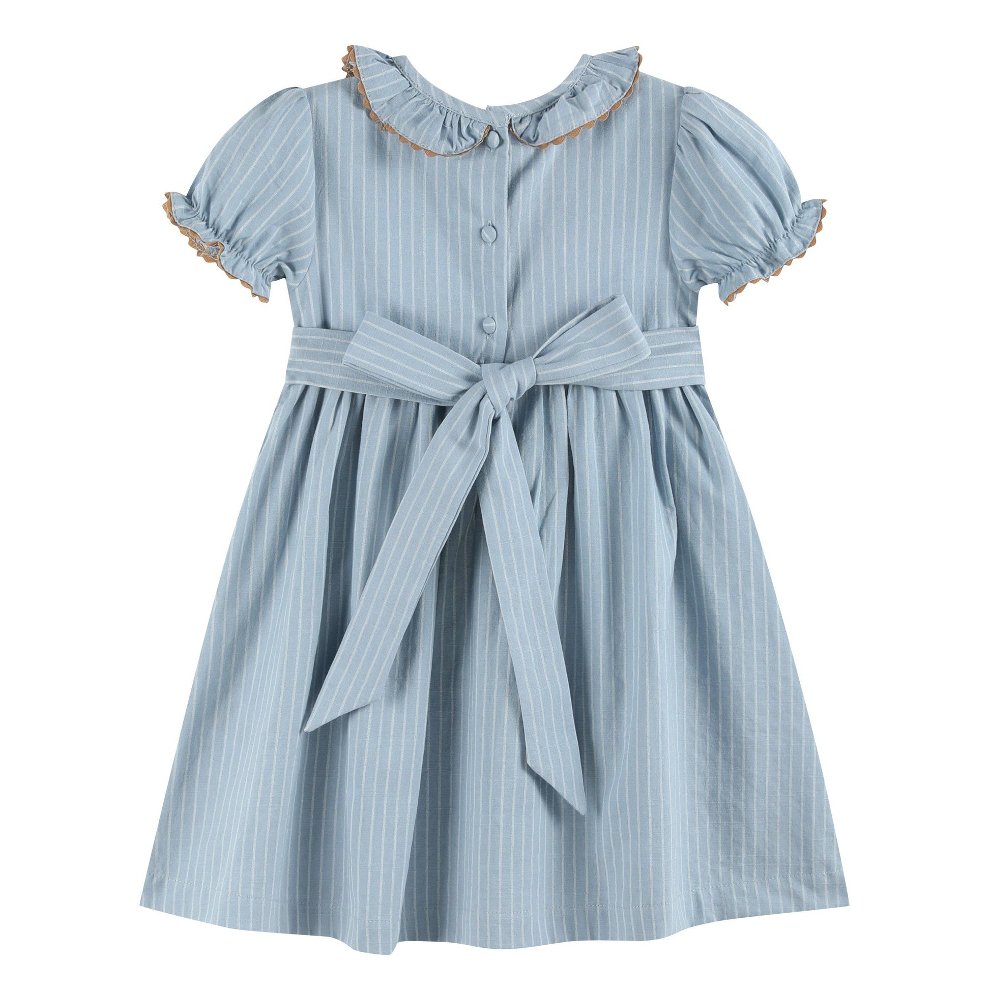 Light blue girls’ dress with white pinstripes, smocked ruffle collar with brown trim, puffed sleeves edged in brown ruffles, and a large waist bow. Size: 12-18M.