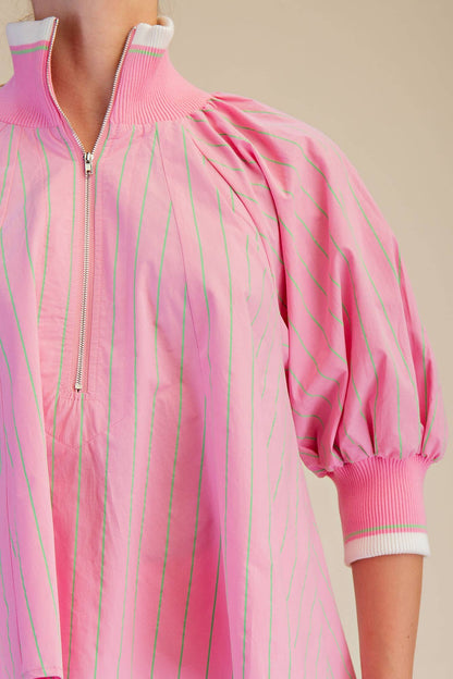 Pink Mock Neck Band Puff Sleeve Blouse with front zipper, ribbed cuffs and collar. Available in sizes S, M, L, XL.