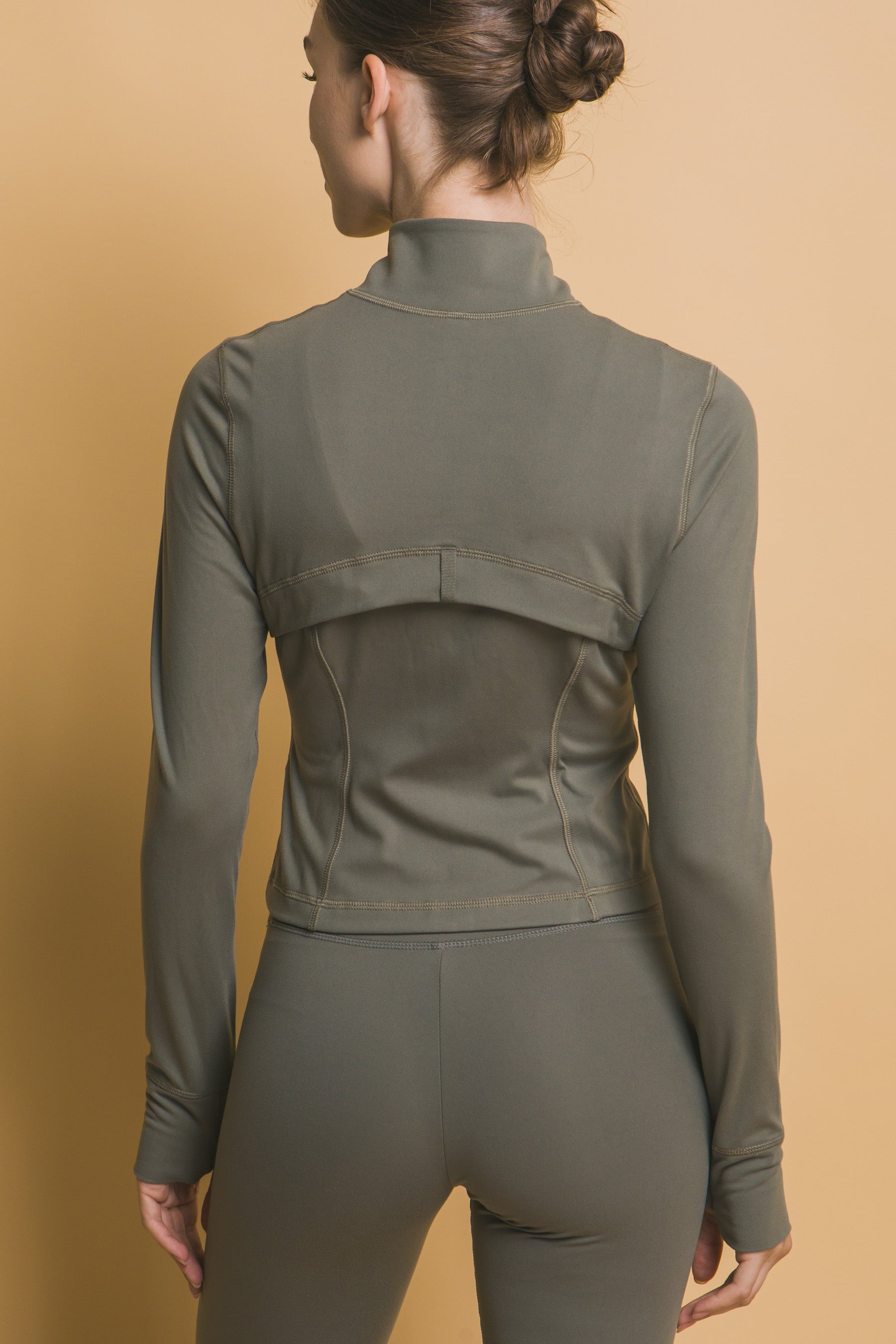 Active Long-Sleeve Zip-Up Performance Top and Leggings in olive green, made from buttery soft fabric. Available sizes: XS, S, M, L, XL.