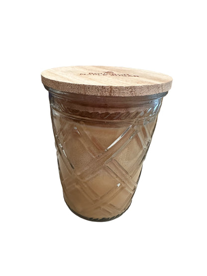 Timeless 12oz jar candle with crisscross glass, light brown Pumpkin Caramel Drizzle wax, and round wooden lid.
