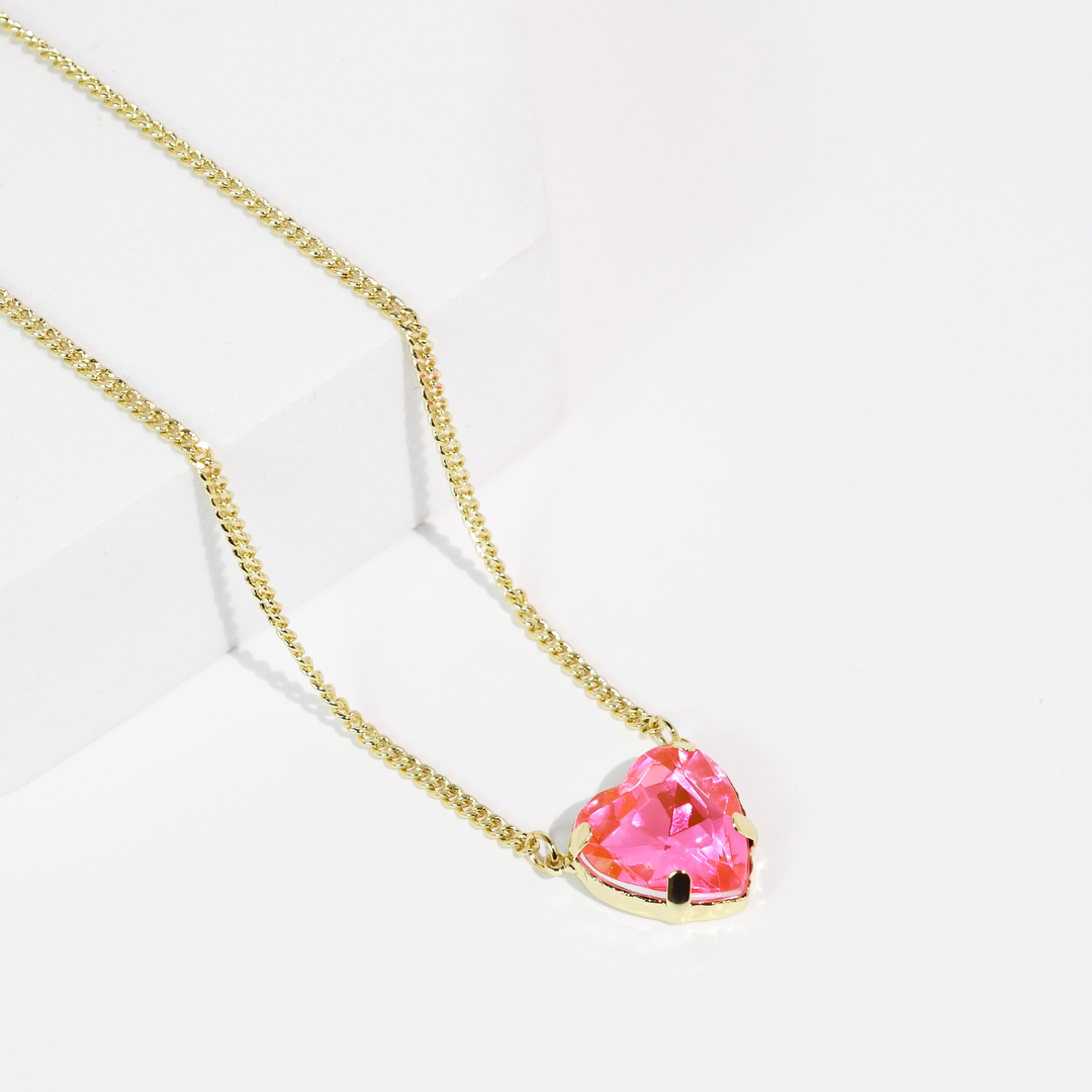 Gold chain necklace with heart-shaped aqua crystal pendant. Available in 16", 18", and 20" lengths.