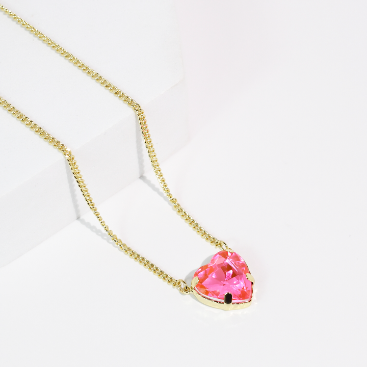Gold chain necklace with heart-shaped aqua crystal pendant. Available in 16", 18", and 20" lengths.