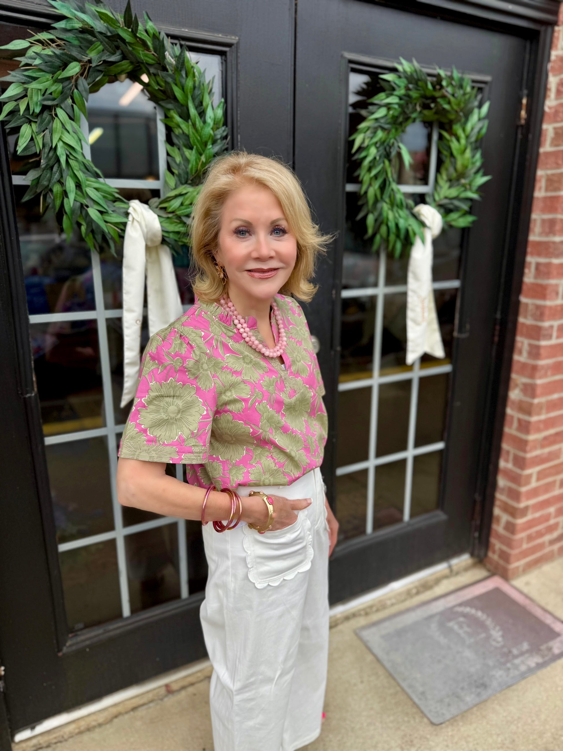 Ramona Garden District Green Top: cotton blend women’s shirt with ruffle V-neck blouse design. Available in sizes XS–XL.