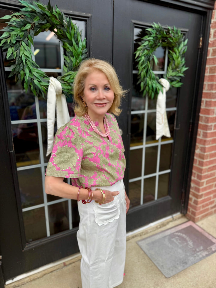 Ramona Garden District Green Top: cotton blend women’s shirt with ruffle V-neck blouse design. Available in sizes XS–XL.