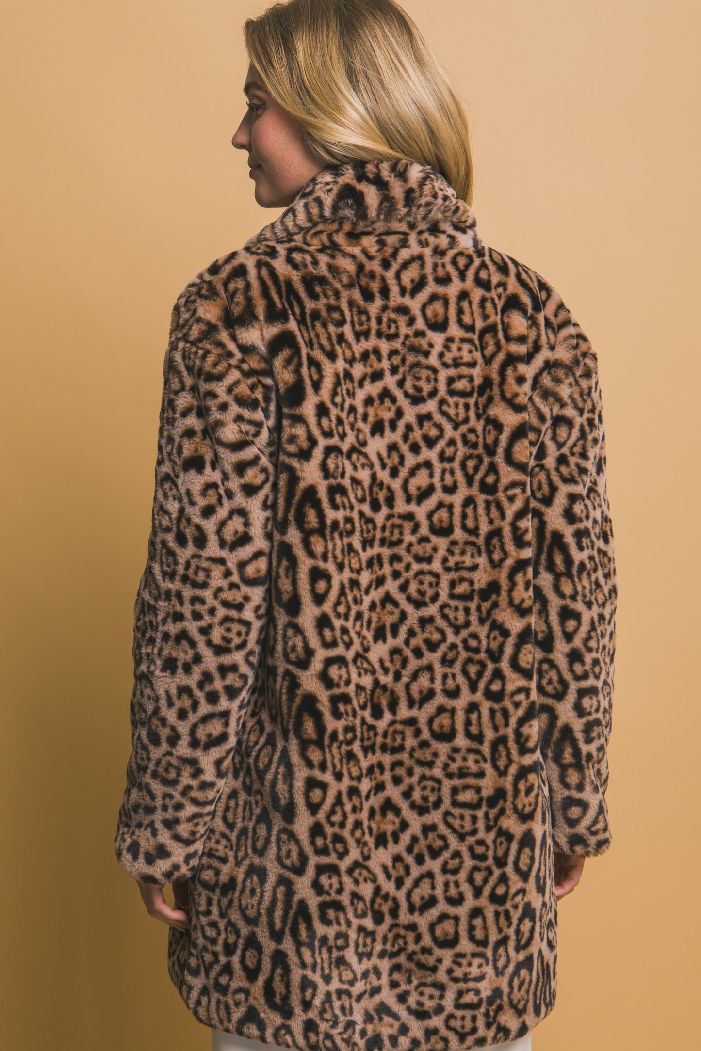 The Animal Print Faux Fur Coat is a stylish winter essential designed in an eye-catching animal print pattern. Available in sizes XS, S, M, L, and XL.