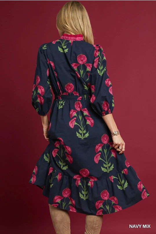 Louise Floral Midi Dress: navy with pink/green florals, long sleeves, ruffled hem. Available in sizes XS–XL.