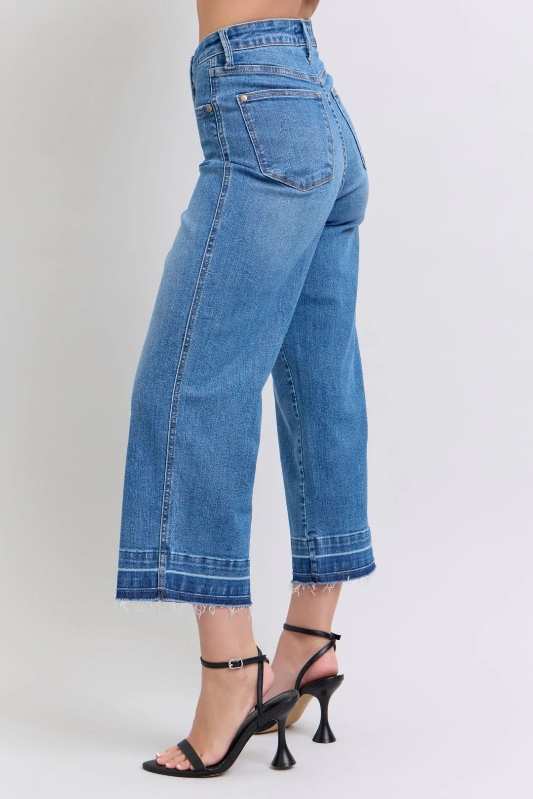 Judy Blue HW Control Release Hem Crop Wide high-waisted blue jeans with frayed hems. Available in sizes 0-20W.