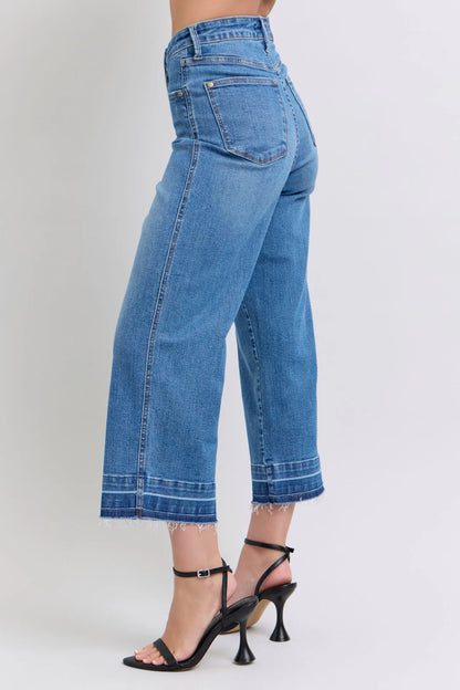 Judy Blue HW Control Release Hem Crop Wide high-waisted blue jeans with frayed hems. Available in sizes 0-20W.