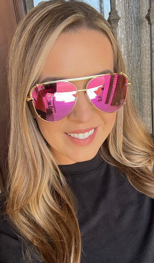 Gold-rimmed Dax Shay Sunglasses with pink reflective lenses, UV 400 protection. Available in S, M, L sizes.