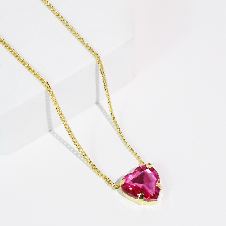 The Berry Crush Necklace: Aqua has a dainty gold chain and aqua heart crystal pendant. Available in 16", 18", and 20" sizes.