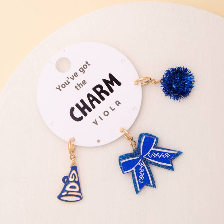 Charm Set: Pom Pom, Megaphone, and Glittered Bow charms in blue. Available in small and large sizes.