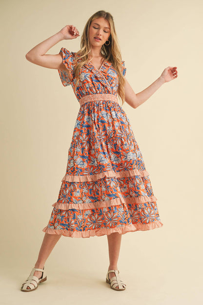 Mixed Floral Print Ruffle Trim Midi Dress with smocked waistband, ruffled sleeves, tiered skirt. Sizes: XS–XL.