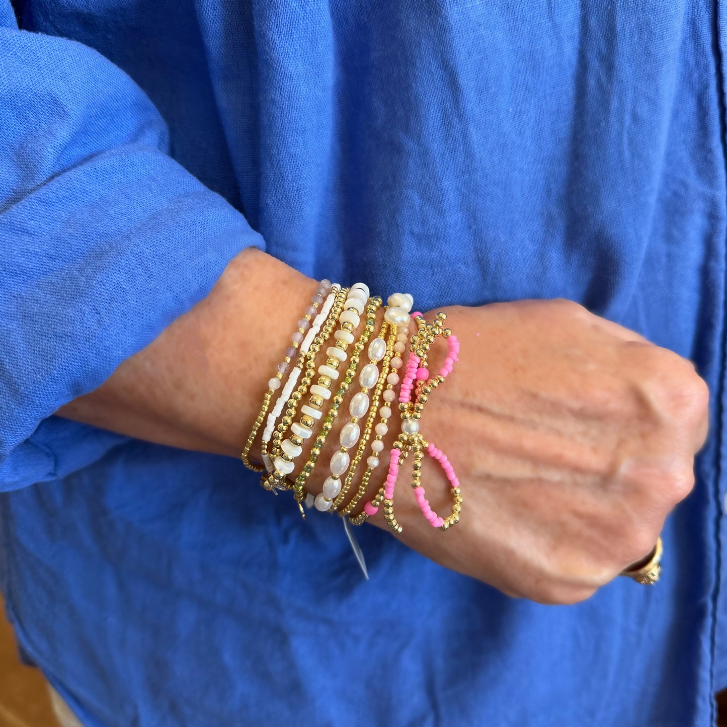 Gold beaded bracelets with gold, white, pink, and pearl accent beads. Available in S, M, L sizes.