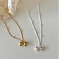 Dainty 925 sterling silver necklace with a small bowknot charm. Available in 16", 18", and 20" chain lengths.