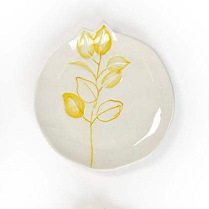 Round white ceramic plates with yellow floral design, uneven edges. Minimalist. Available in 6-inch and 8-inch sizes.