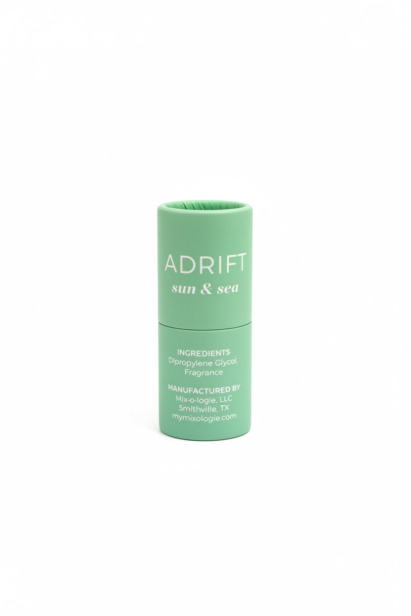 Green cylindrical "ADRIFT sun & sea" Keychain Mini Rollerball Perfume, available in mini size. Ideal for sensitive skin.