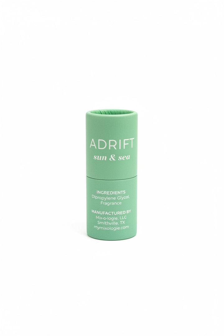Green cylindrical "ADRIFT sun &amp; sea" Keychain Mini Rollerball Perfume, available in mini size. Ideal for sensitive skin.
