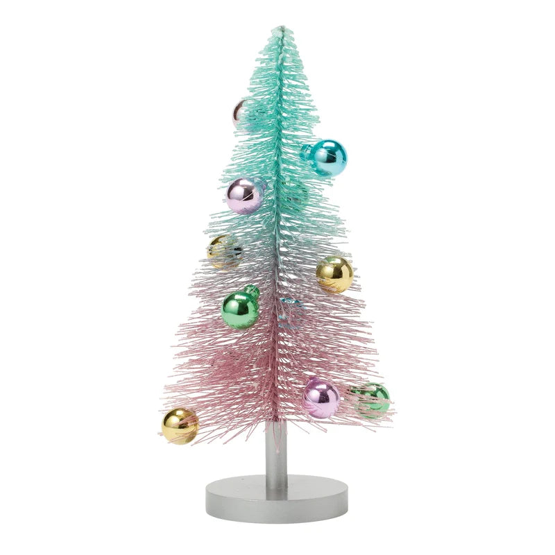 Gradient Bottle Brush Tree in pink and aqua with colorful ornaments on a silver pedestal base.