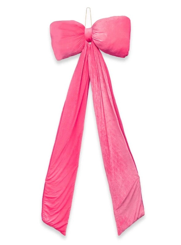 Oversized velvet pink decor bow with long fabric tails.
