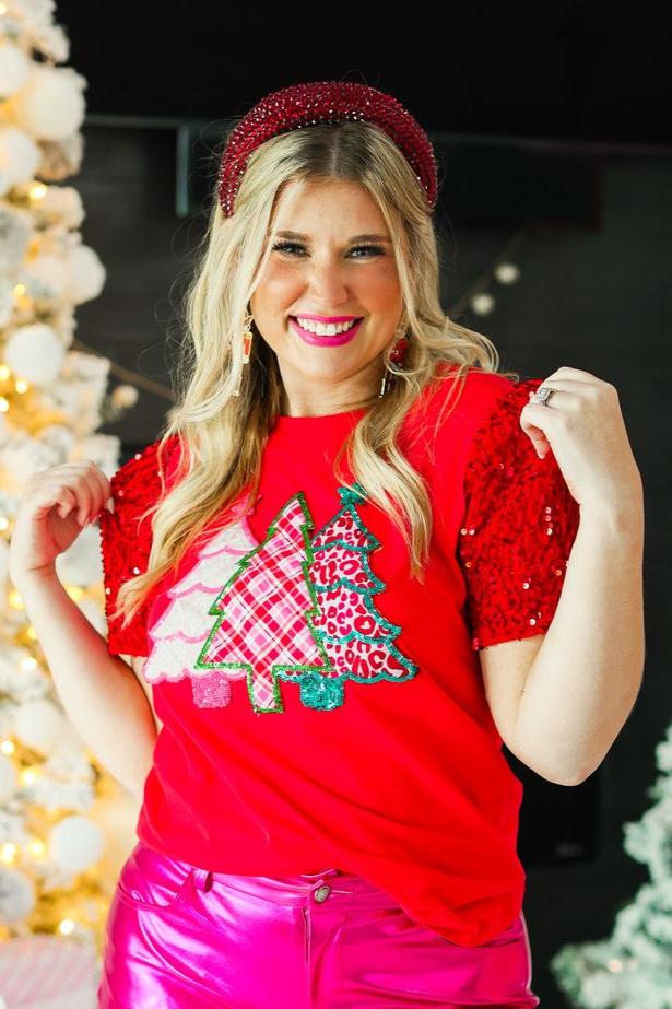 Red relaxed fit top with sequined short sleeves and three patterned Christmas tree appliques.