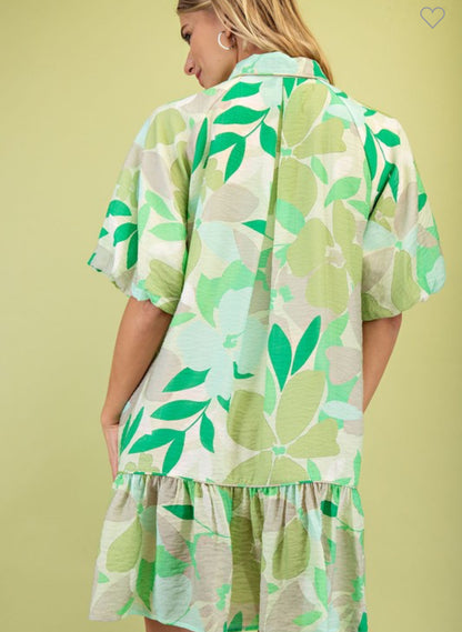 Penny Floral Print Mini Dress: loose fit, short sleeves, green-and-white leafy print, ruffled hem. Sizes XS–L.