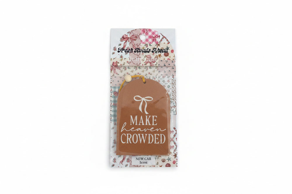 Brown tag-shaped air freshener with white bow, "MAKE HEAVEN CROWDED" text; NEW CAR scent. Sizes available: not specified.